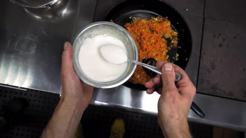 Chef Adds Sugar to Vegetables Cooking in Pan
