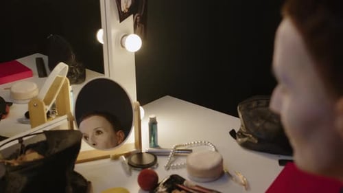 Mime Performer Powdering Face in White while Getting Ready in Backstage Room