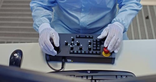 Hands Operate Complex Control Panel in Sterile Environment