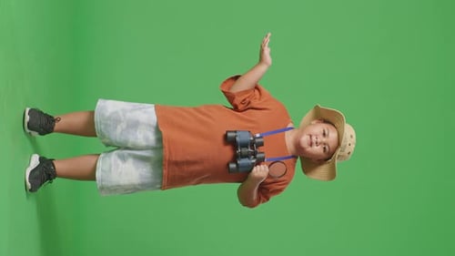 Asian Tourist Boy Researcher Holding The Magnifying Glass And Pointing To Side