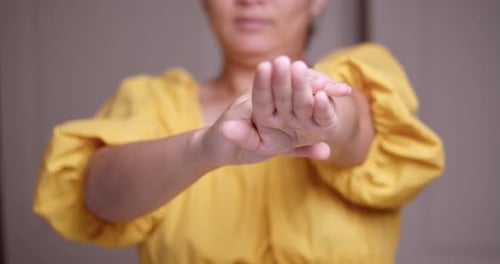 Woman Massages Lotion Onto Her Hands