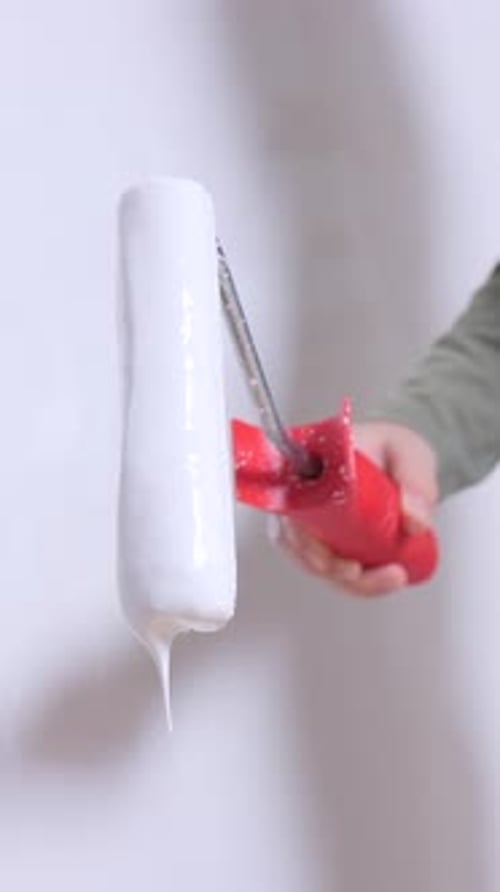 Vertical Video Little Girl Painter Using Paint Roller Painting Wall White During Renovation Work