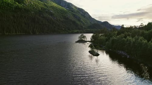 Tranquil Mountain River Framed By Vibrant Green Mountains