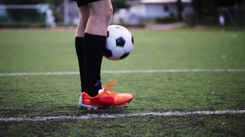 Professional footballer performing impressive juggling tricks on the field