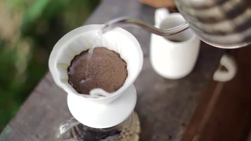 Pouring Water over Coffee Filter to Make Coffee
