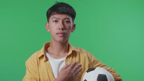 Young Adult with Soccer Ball on Green Screen