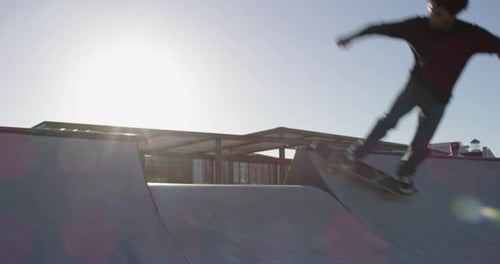 Man, stunt and skateboard at park outdoor for sport, freedom and training with sunshine or summer
