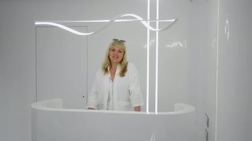 A Woman Stands at the Reception Desk