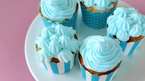 Cupcakes with blue cream .Top view. Rotate. delicious portioned cakes.