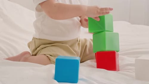Toddler Stacking Colorful Blocks Indoors in a Cozy Home Environment