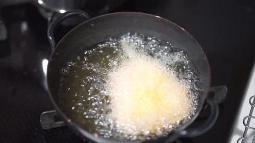 Fish Being Deep Fried in Hot Oil