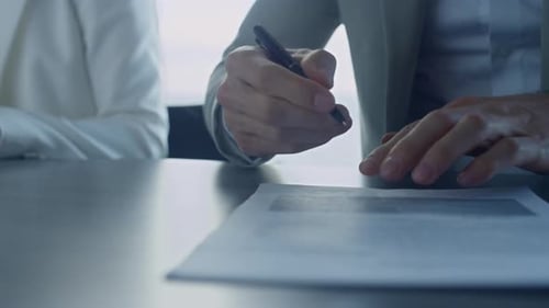 Closeup Man Hand Signing Contract in Office. Financial Manager Writing Hold Pen