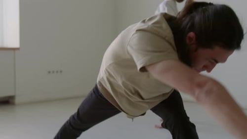 Dancers Doing Dynamic Stretch and Warming Up for Rehearsal in Studio