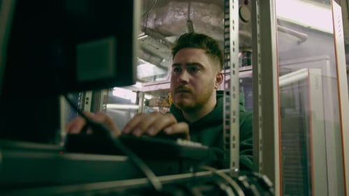 focused hacker in data center hacking software system vulnerable cyber security server room