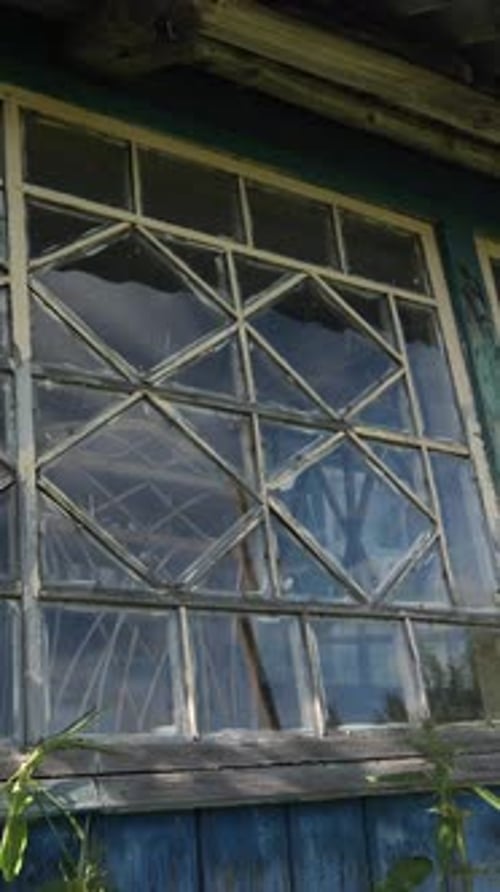 Vertical Video Window in an Abandoned Wooden House in the Village Broken Window