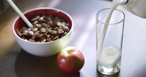 Preparing a Glass of Milk for Breakfast Meal