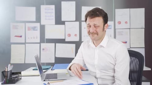 Professional Man Presenting Information at Desk