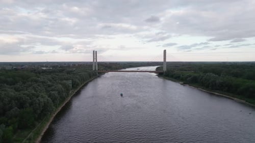 Drone aerial view of River Vistula in Warsaw and Siekierkowski bridge in foreground 4K