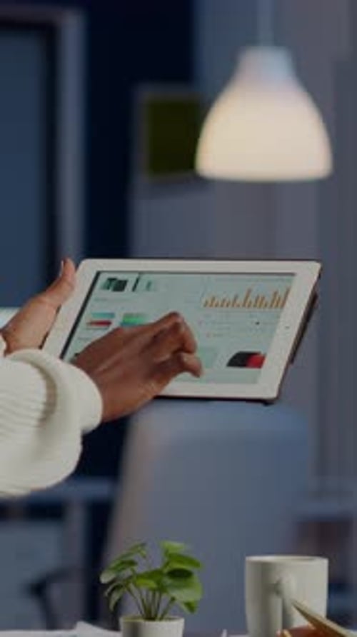 African Freelancer Woman Holding Tablet Checking Financial Graphs