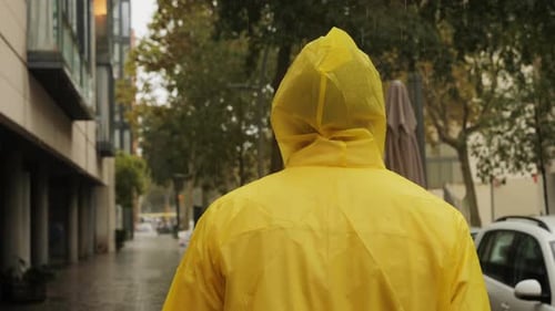 Business Man Tourist Person with Umbrella and Raincoat on Rainy European City Street Lights