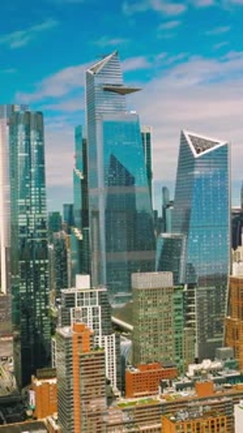 Azure sky reflecting in the mirror windows of skyscrapers. New York city diverse architecture