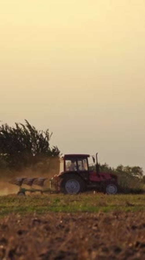 Tractor in the field in rural place. Agricultural machinery on the soil during seasonal works.