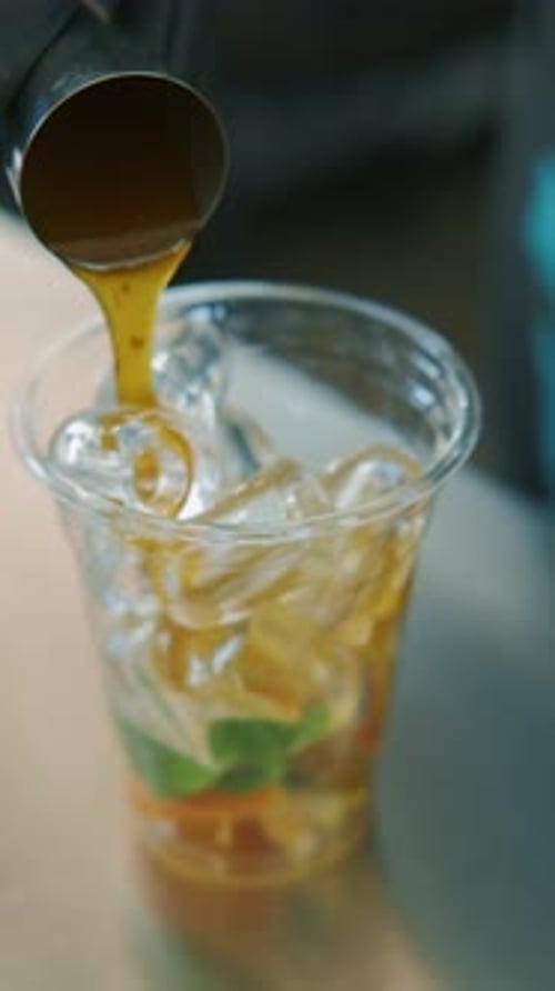 Crafting a Refreshingly Cool Drink Using Ice and Fresh Colorful Ingredients for Enjoyment