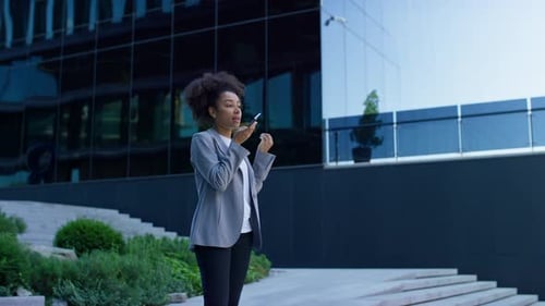 Woman Talking on Phone Outside Office Building