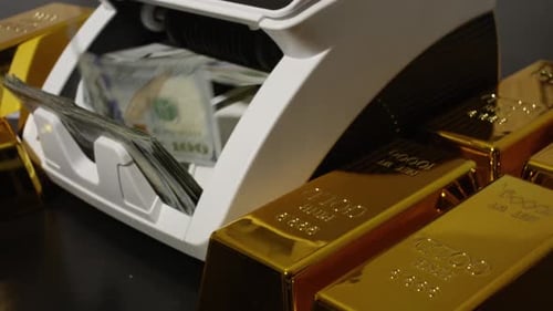 Money Counter Processing Currency with Gold Bullion