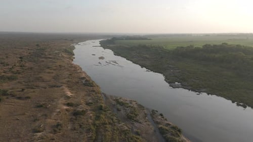 Slow drone descent onto the seasonal crocodile river in the Kruger National Park.