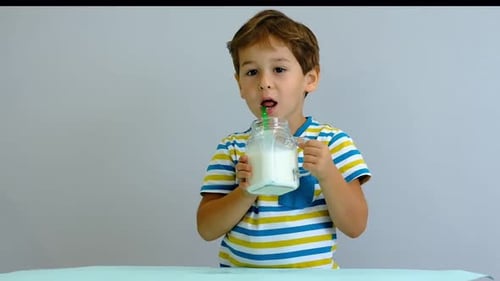Young Boy Enjoying Milk Drink Indoors