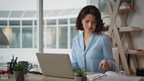 Financial Manager Working Company Office with Laptop and Documents Efficiently