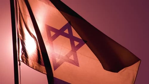 Israeli Flag Waving on Flagpole in Pink Sky