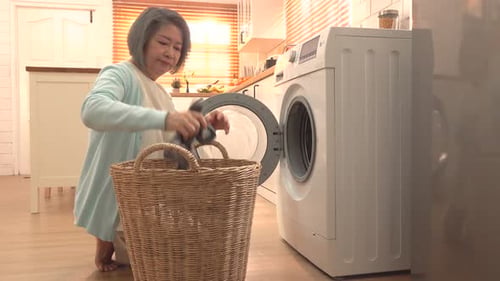 Senior Woman Doing Laundry in Bright Kitchen
