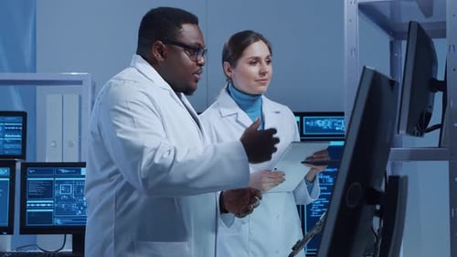 Scientists Discussing Data in Modern Research Laboratory