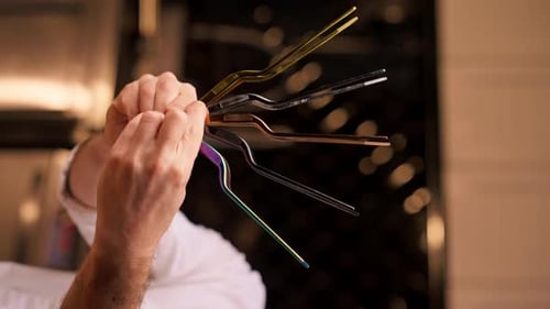 Chef Hands Displaying Modern Culinary Tongs Collection