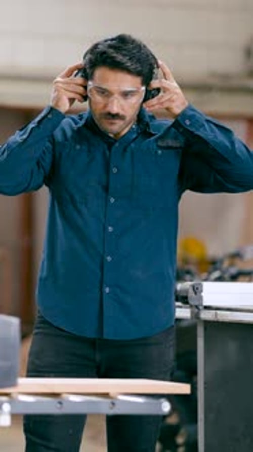 Man Preparing Woodworking Tools and Safety Equipment