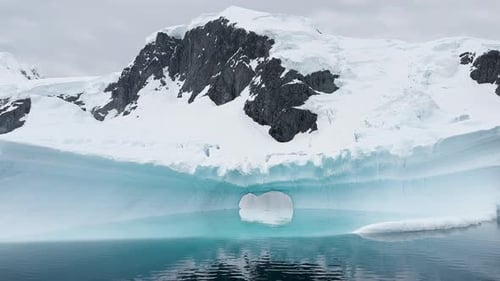 Arch in a Huge Iceberg High Breakaway Glacier Drifts in the Southern Ocean Off the Coast of