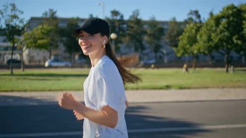 Happy Girl Jogging Road Wearing Wireless Earbuds Closeup Smiling Woman Running