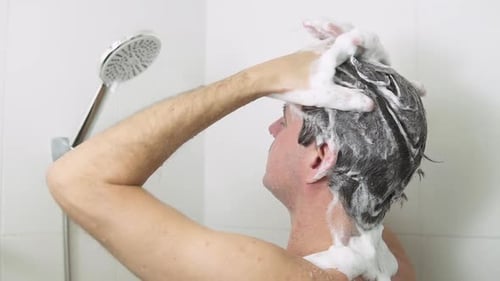 Man Washing Hair with Shampoo in Shower
