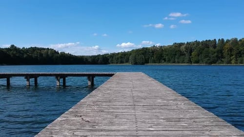 Flying above fishing pier and lake