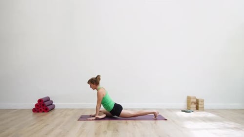 Woman in centered relaxation posture in green garden