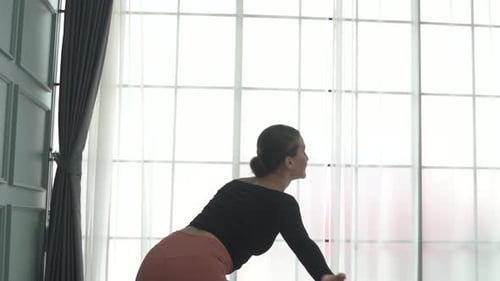 Friends practice ballet dance at studio.