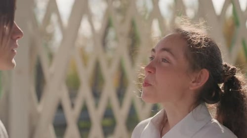 Loving Young Couple Embracing Outdoors in White Clothing