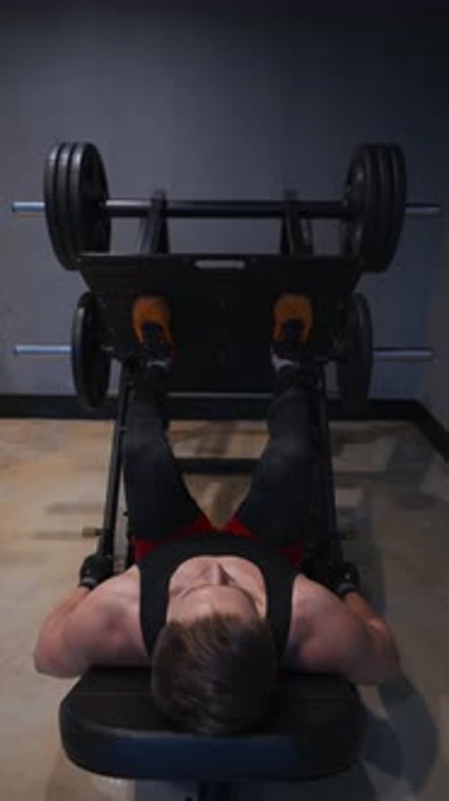 Man Doing Heavy Leg Press in Gym
