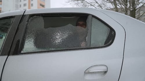 Man Punches Icy Car Window, Smashing Glass