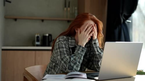Exhausted Female Student or Worker Sit at Home Office Desk Looking Away Having Sleep Deprivation