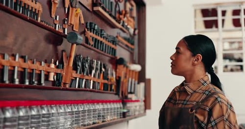 Leather, tools and designer with woman in workshop for tailor, entrepreneur and small business