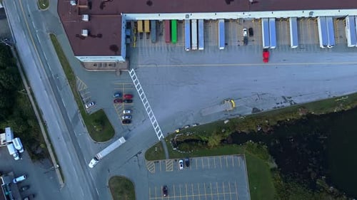 Top View Warehouse With Trucks Loading Goods At Industrial Distribution Center