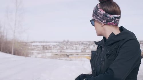 Female Runner Touching Smartwatch On Road